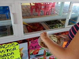 This taco place had a refrigerated buffet-style taco condiment stand.